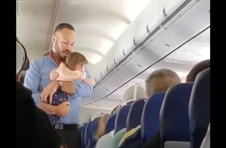 15 minutes after family can’t quiet crying baby on plane male flight attendant walks over & grabs her