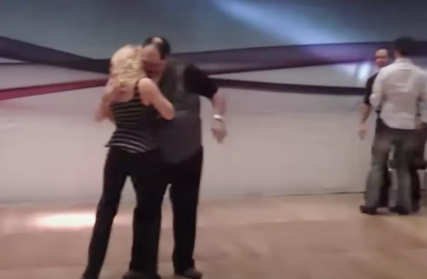 Husband watching on has to be held back when wife’s dance routine gets too saucy